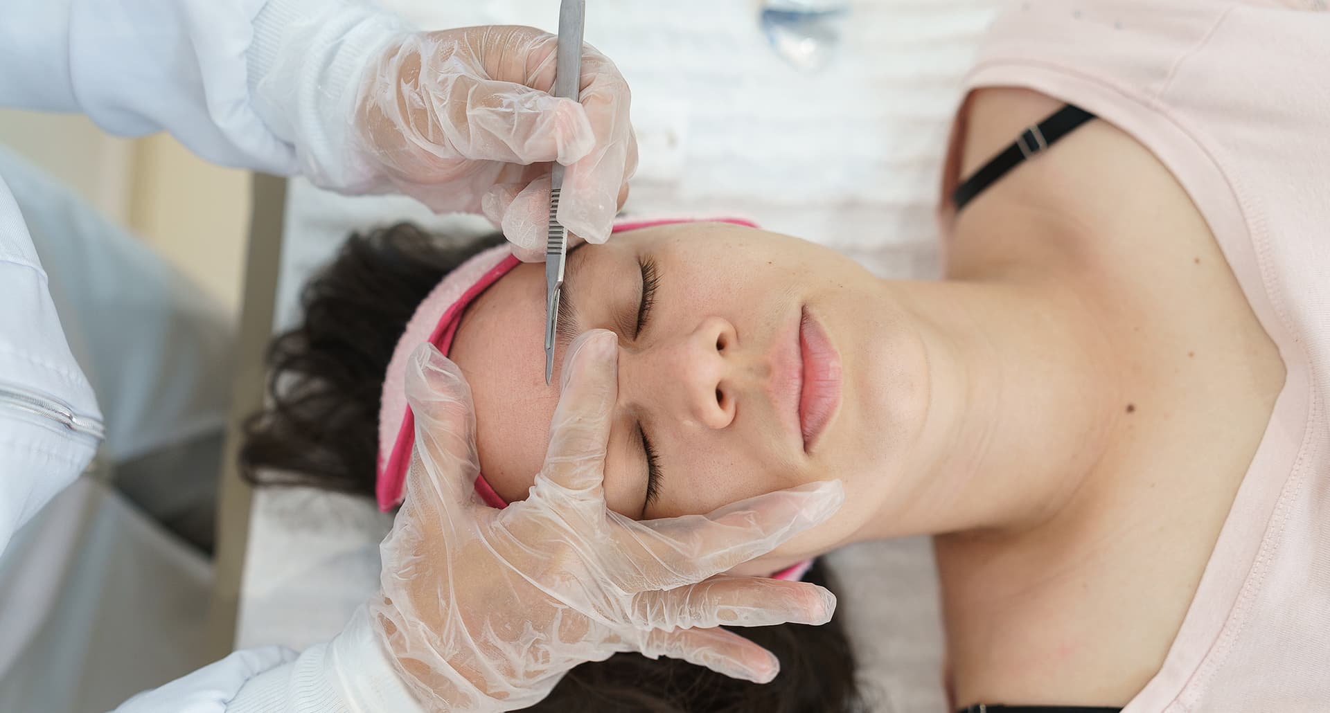 what is dermaplaning universal: a woman getting her face dermaplaned
